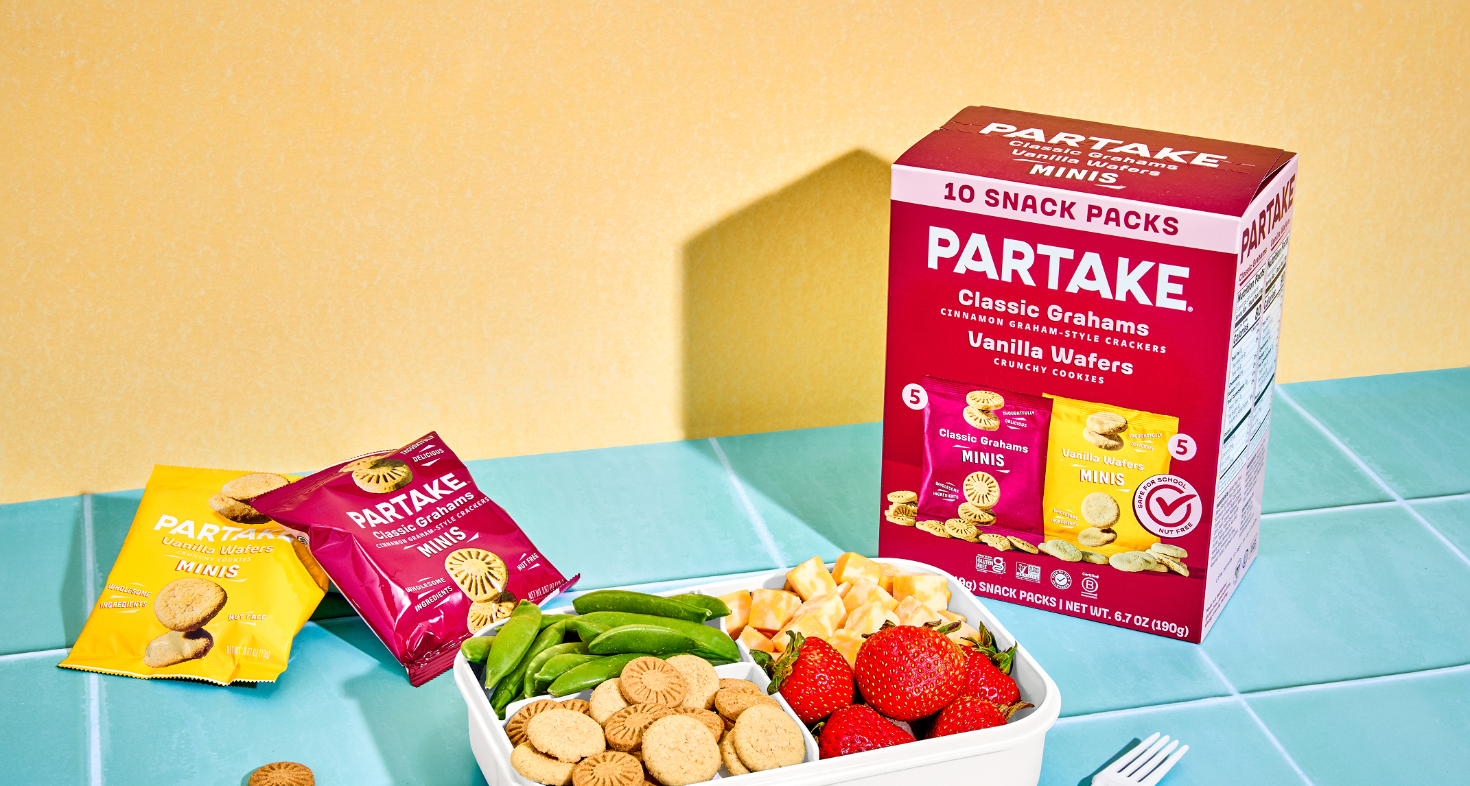 Partake snack packs on a table with a colorful background